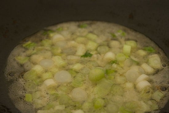 frying spring onions in oil.