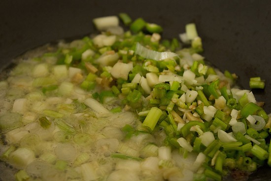 remaining aromatics added to spring onion pan for making dry manchurian mushroom sauce.