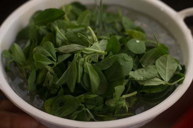 soaking fresh methi in water.