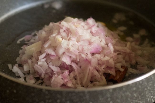 finely chopped onion added to whole masala in pan.