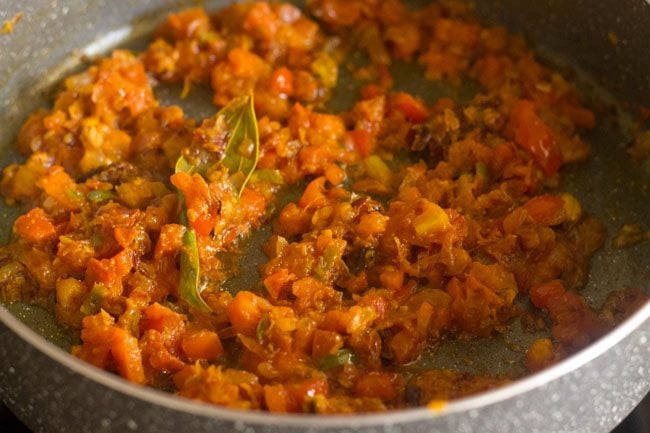 tomato onion masala is well cooked, with oil releasing from the sides.