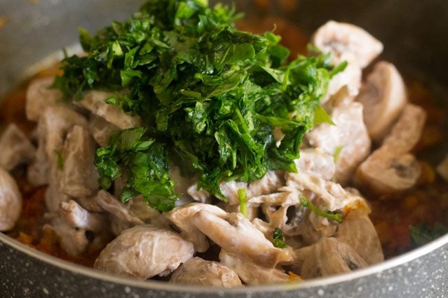 methi leaves added on top of the mushrooms.