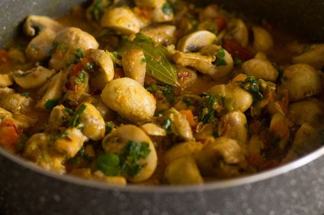 stirring mushroom methi to combine.