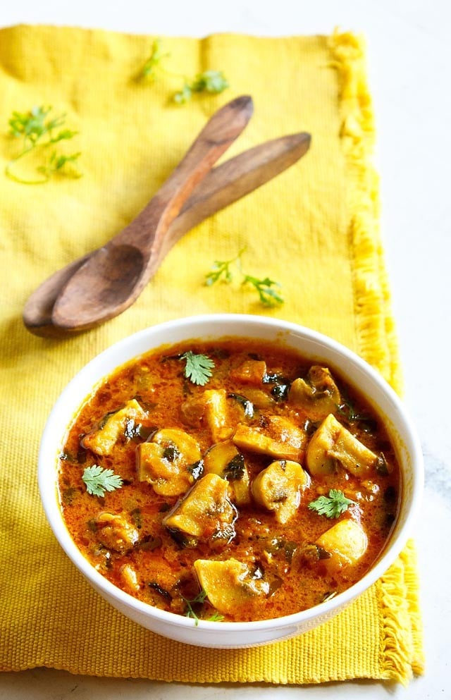 methi mushroom in a white bowl on a yellow napkin.