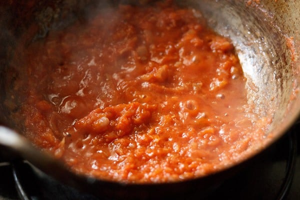 sautéing tomato puree till some oil releases from the sides