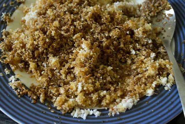 mixing fresh grated coconut, powdered jaggery, cardamom powder and grated nutmeg to make the sweet filling. 