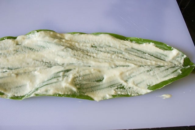 Spread the rice paste over the turmeric leaves. 