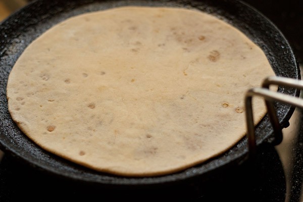 puran poli added to tawa to roast