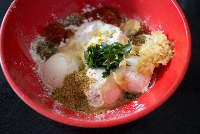 ingredients for potato 65 batter in a red bowl.