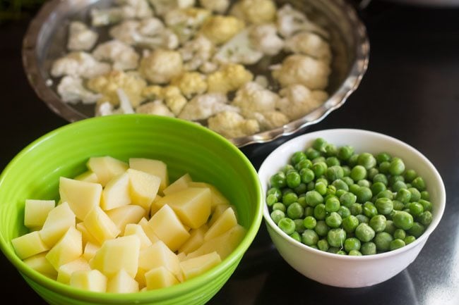 chopped potatoes, chopped cauliflower and green peas for aloo gobi matar