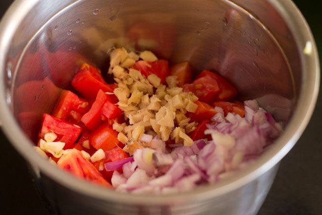 adding chopped vegetables for paste in blender jar