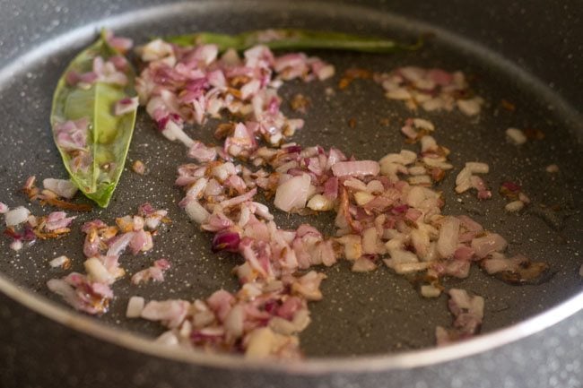 frying chopped onions in pan