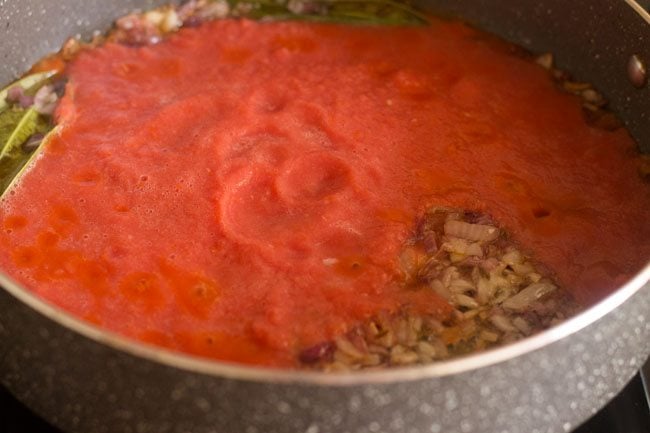 adding ground onion-tomato paste in pan