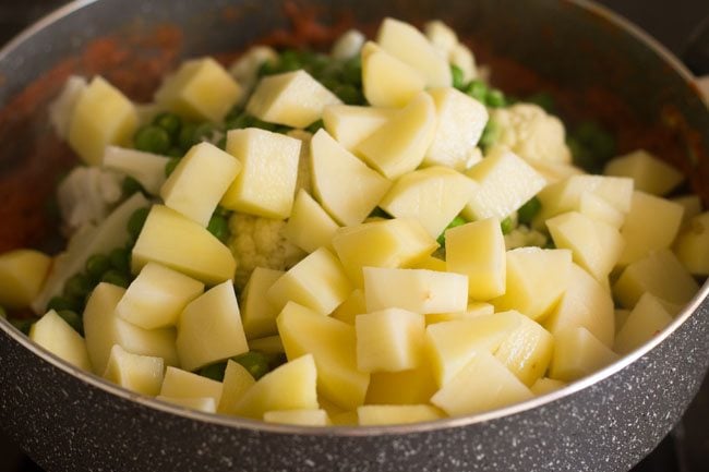 adding chopped potatoes to pan