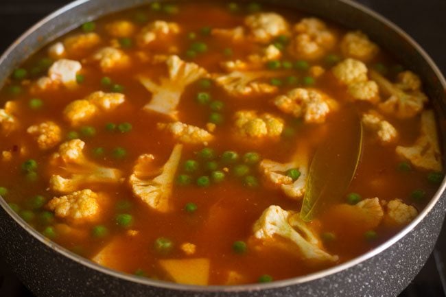 adding water to pan for the curry of aloo gobi matar