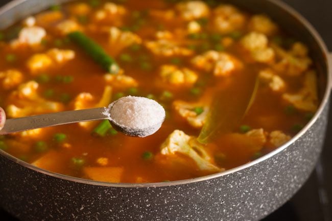 adding green chilies and salt to the pan 