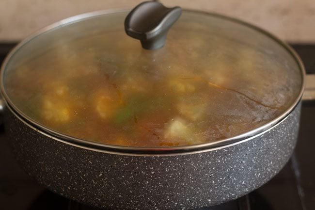 simmering aloo gobi matar in pan