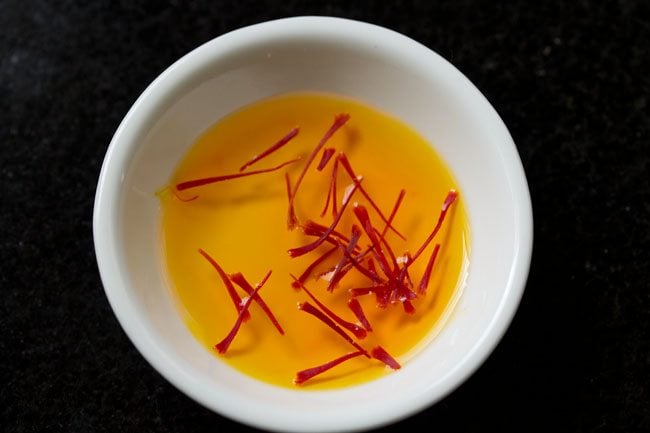 saffron strands in hot water in a bowl