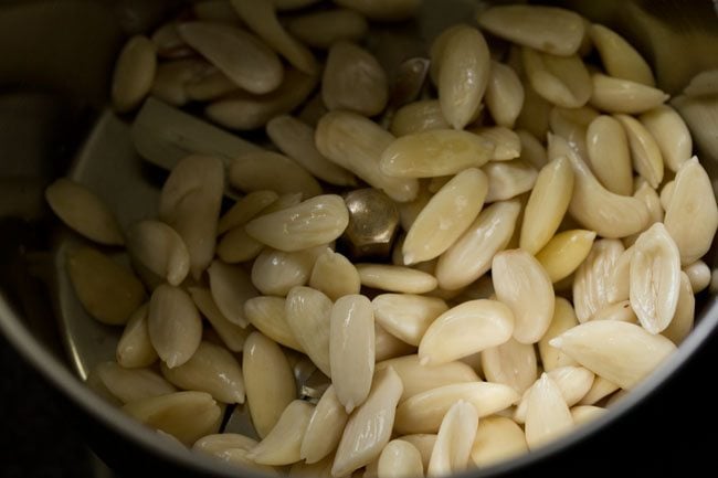 peeled almonds in a grinder