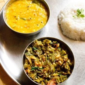 bhindi ki sabji served with dal and steamed rice in steel bowls