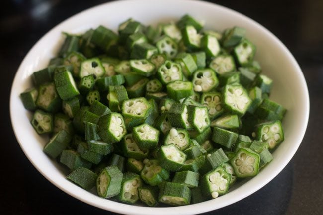 chopped okra in a white bowl to make bhindi ki sabji