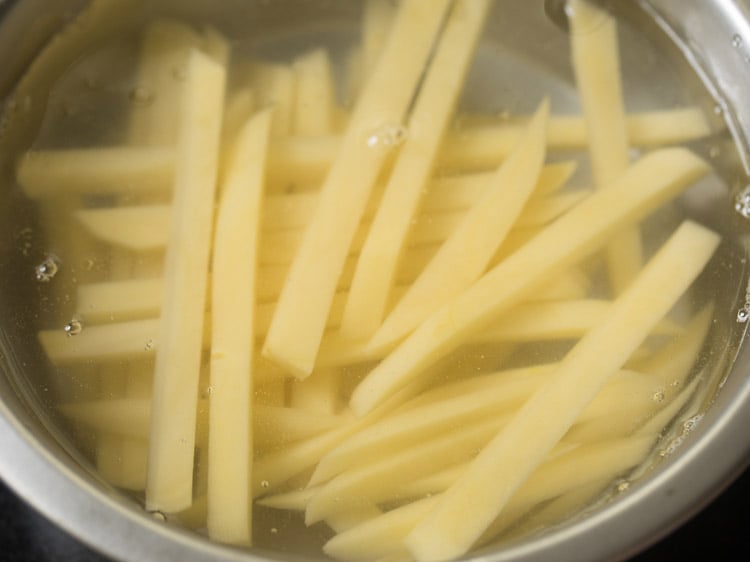 potato sticks soaking in water to remove excess starch