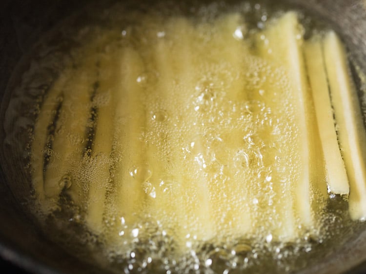 oil is bubbling around potatoes