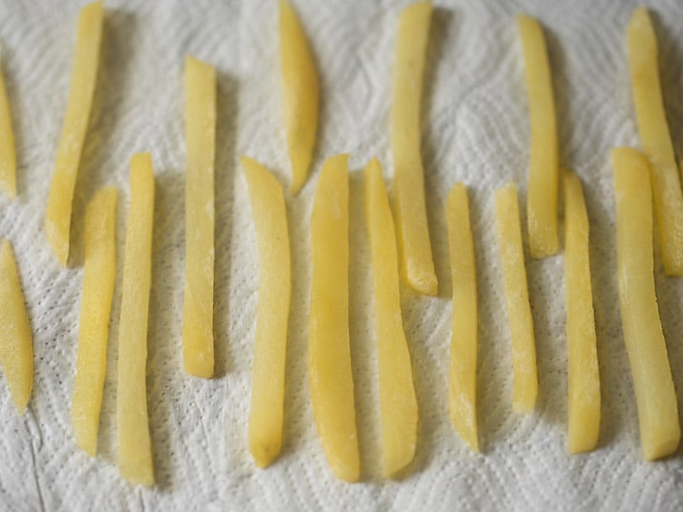 potatoes are draining excess oil on paper towel lined plate