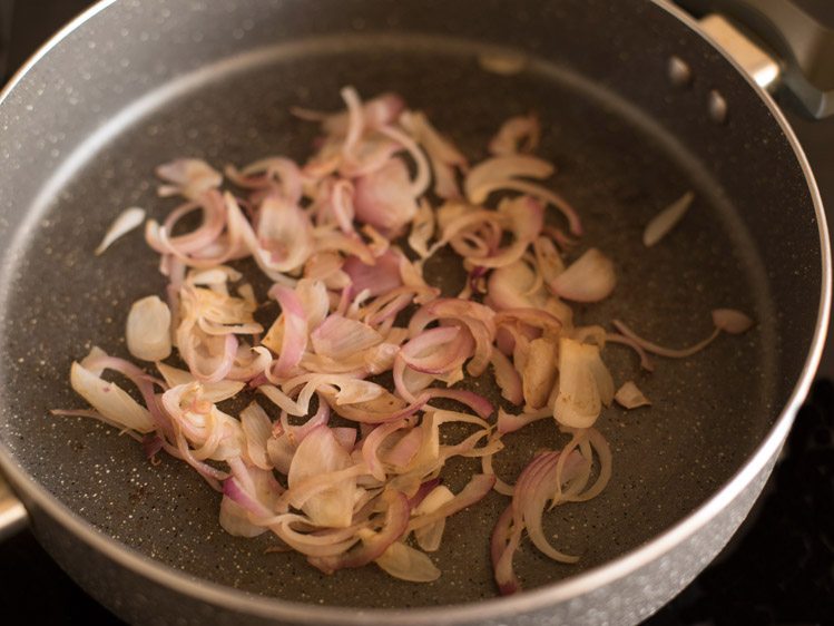 browning sliced onions in a pan