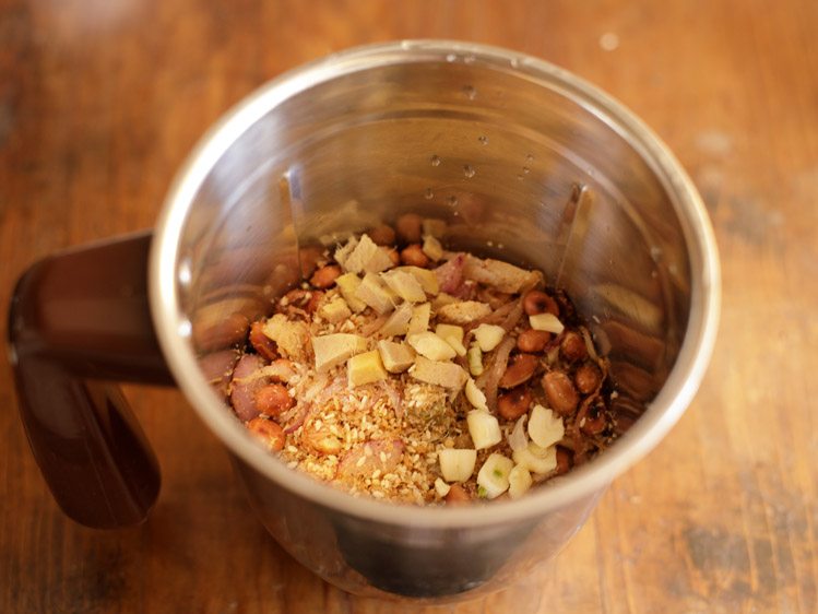 roasted mixture, chopped garlic and chopped ginger in a blender jar