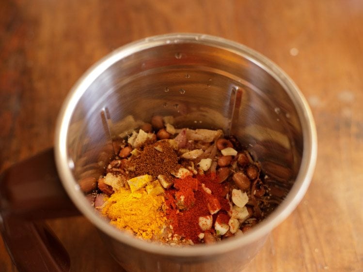 adding red chili powder, turmeric powder and garam masala powder in the blender jar