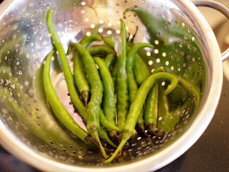 rinsing green chilies in water 