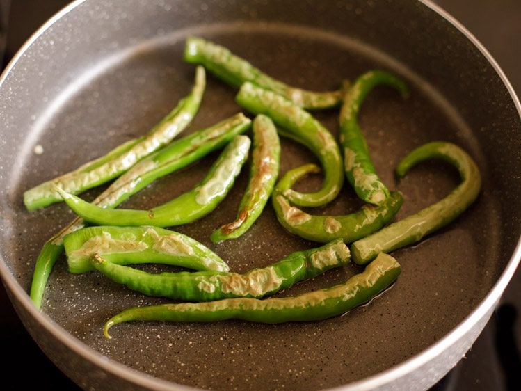 frying green chilies till lightly browned from both sides
