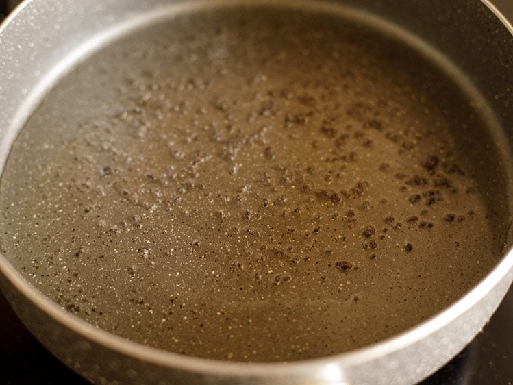 frying mustard seeds in hot oil in pan