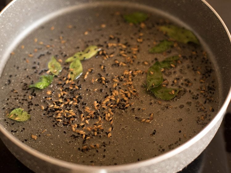 adding curry leaves in pan and frying the mixture