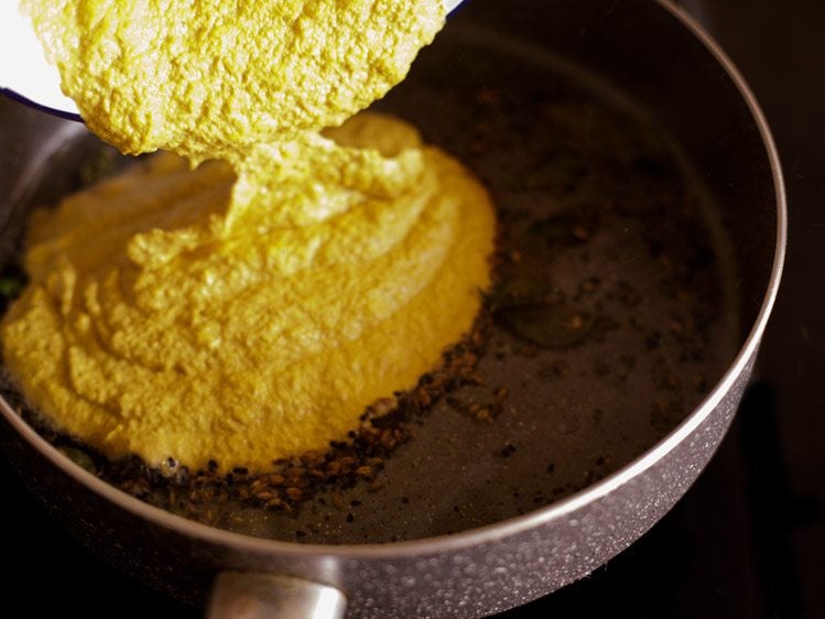 adding the ground masala paste in the pan