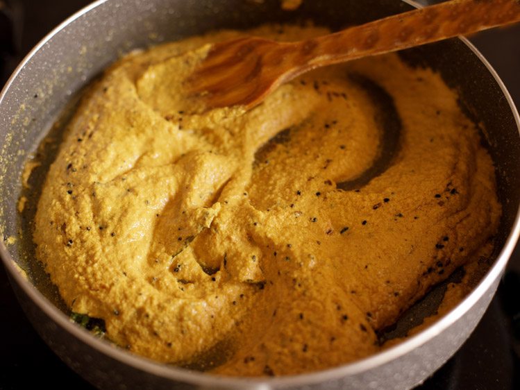 stirring ground masala paste in pan