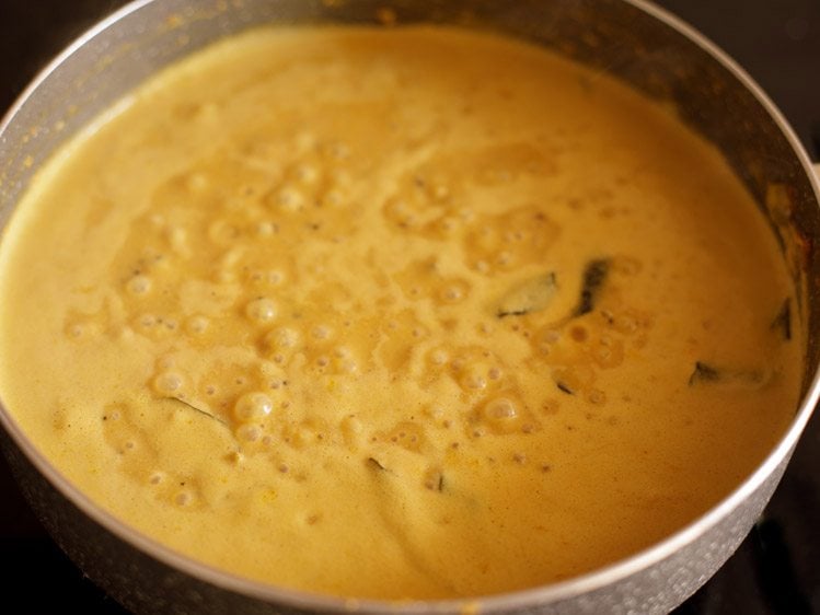 simmering masala curry mixture in pan
