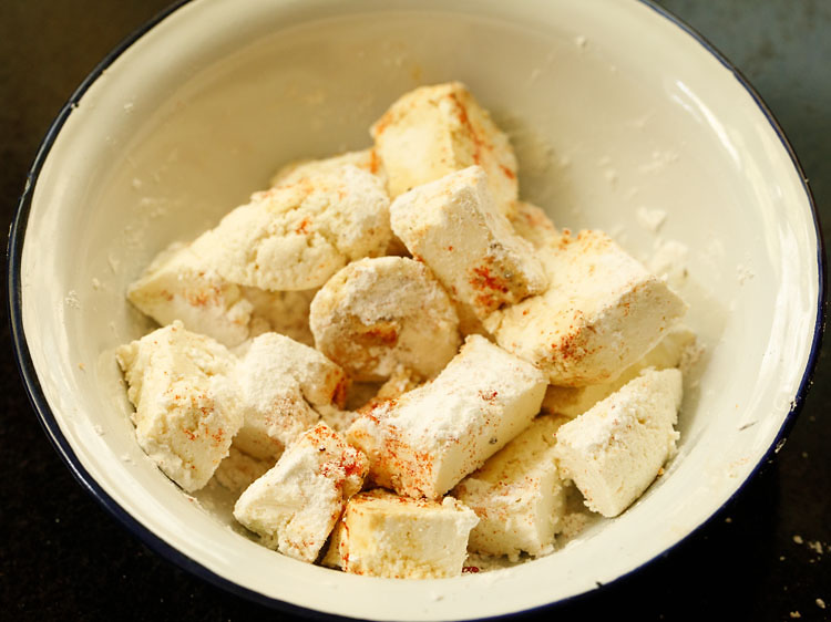 In a bowl take paneer cubes, tapioca starch and spices for marination