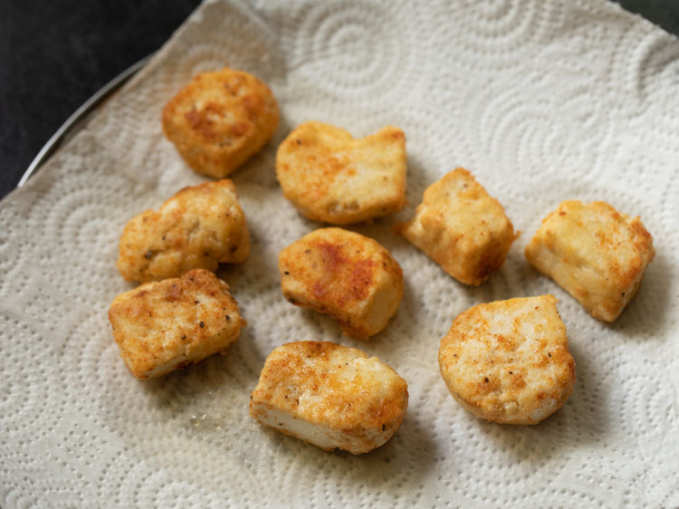 fried paneer cubes on kitchen paper towels