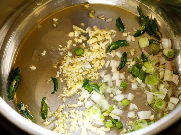 add spring onions, green chillies, ginger and garlic in oil in instant pot