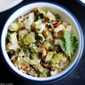 khamang kakdi in a blue rimmed white bowl