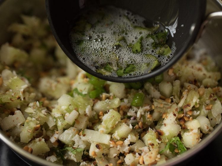 adding tempering mixture to cucumber mixture