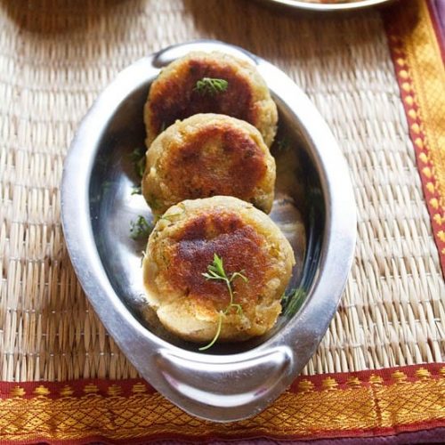 sweet potato cutlet garnished with coriander leaves and served in a steel platter.