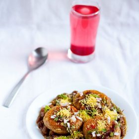 aloo tikki chole served in a white plate with spoon
