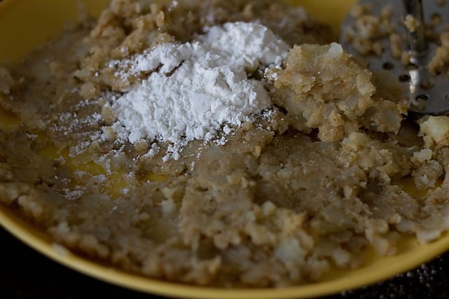 adding cornflour to mashed spiced potatoes on plate