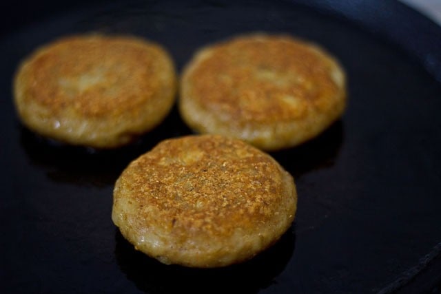 flipping and frying tikkis on tawa