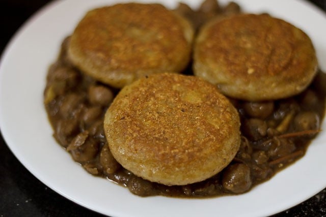 aloo tikki placed on top of chole