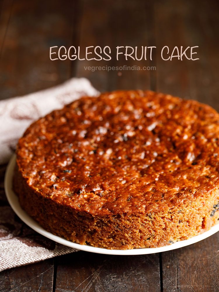 eggless fruit cake placed on a white plate with a printed napkin at the side