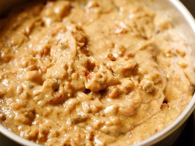 eggless fruit cake batter poured in the prepared baking pan